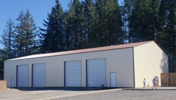Exterior view of a custom gable pole barn with metal siding and sliding door built by Locke Buildings in Oregon